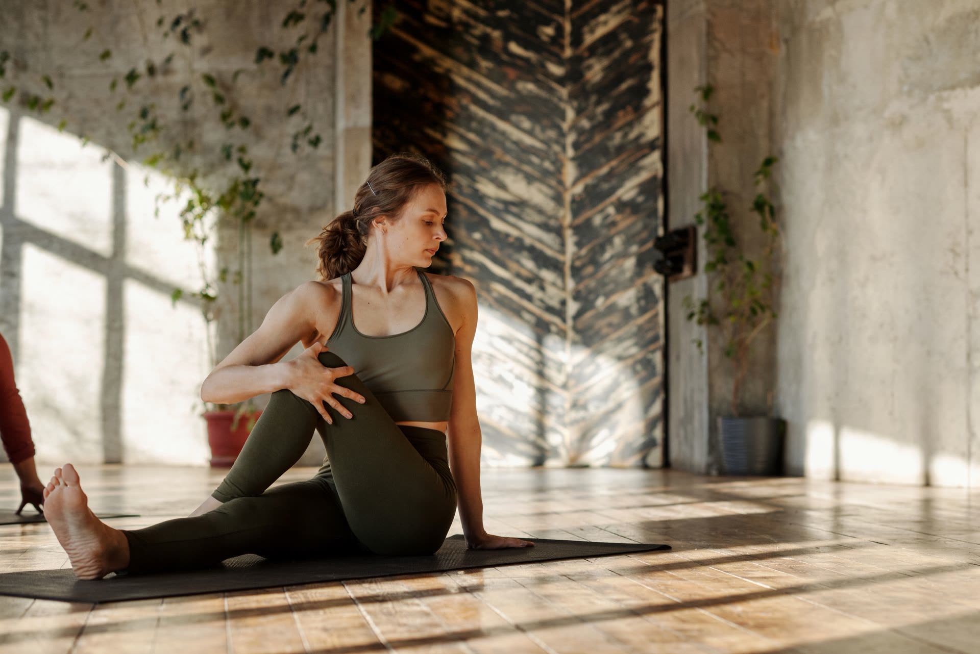 A woman stretching outdoors in morning light